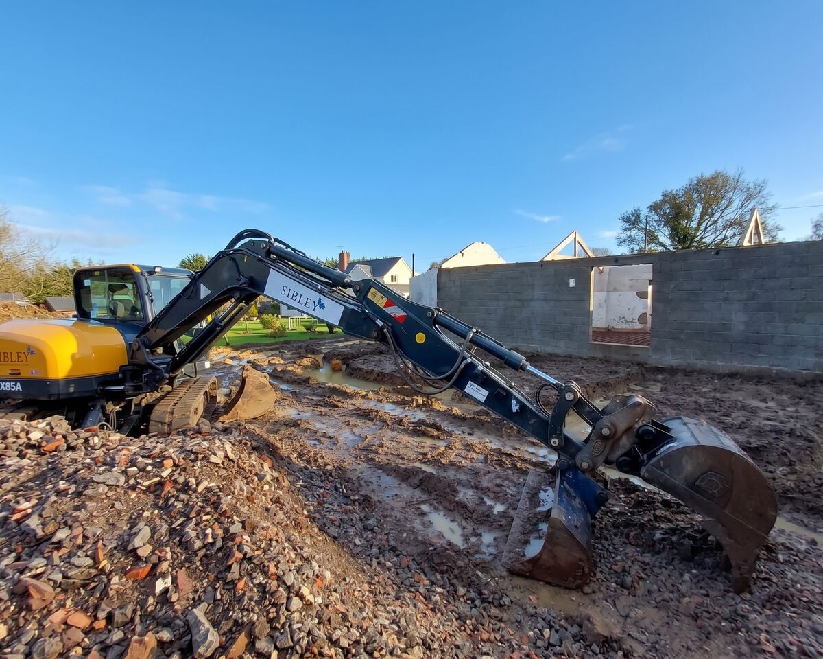 Excavator digging footings at barn conversion, Ashill, Somerset