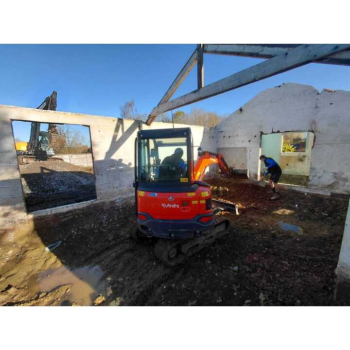Mini digger excavating inside existing barn, Ashill, Somerset