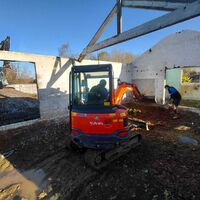 Mini digger excavating inside existing barn, Ashill, Somerset