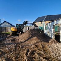 Excavator clearing spoil at barn conversion, Ashill, Somerset